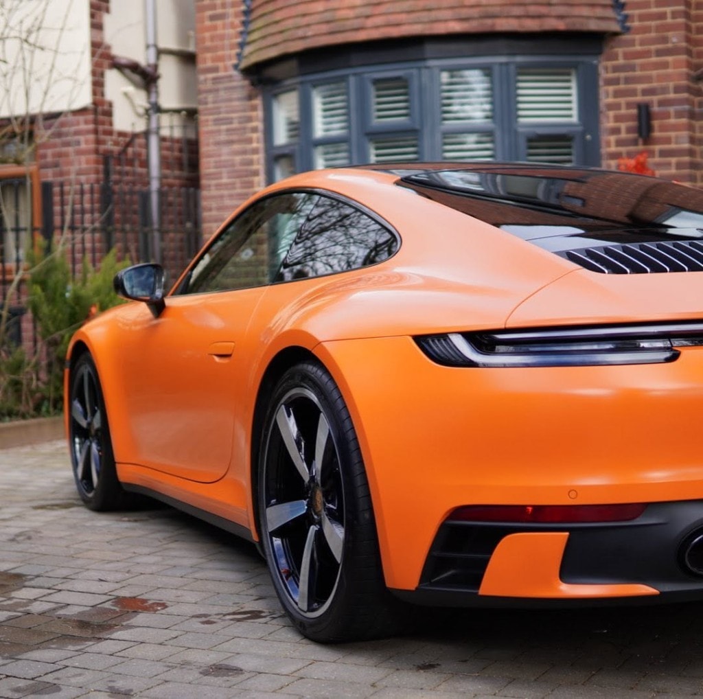 Porsche 911 Turbo S in satin black — sunset silhouette