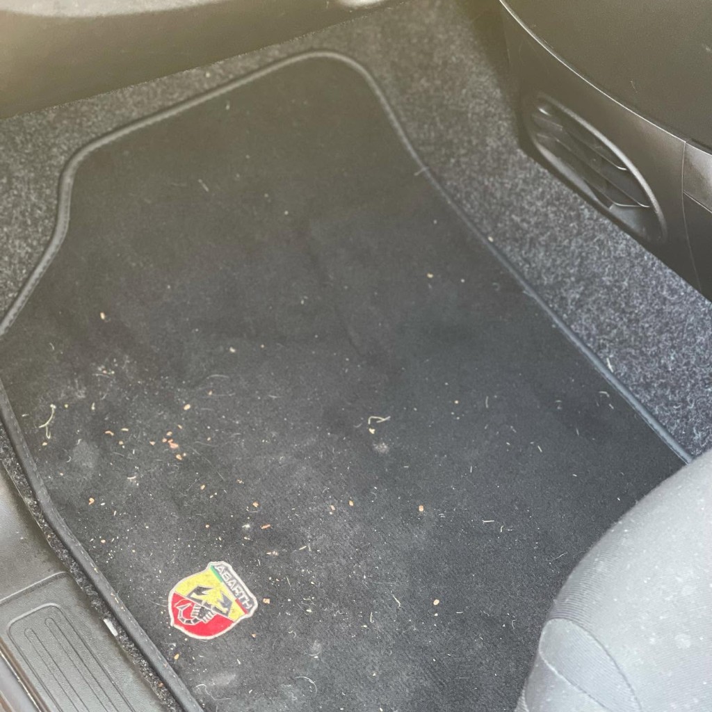 Abarth floor mat before — covered in crumbs and debris