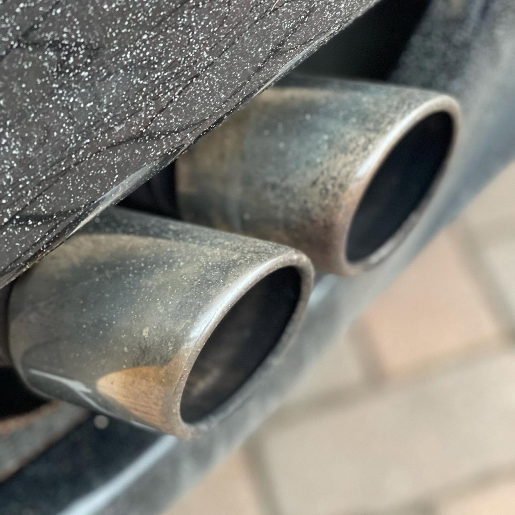 Ferrari 360 exhaust tips before — tarnished and discoloured