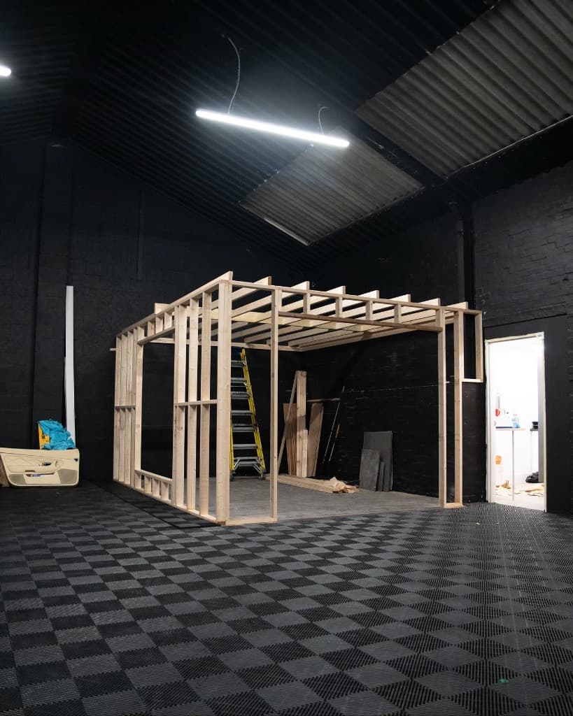 JnJ Detailing studio under construction — timber frame structure inside the industrial unit