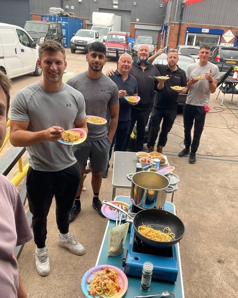 The JnJ Detailing team cooking and sharing a meal together at the unit