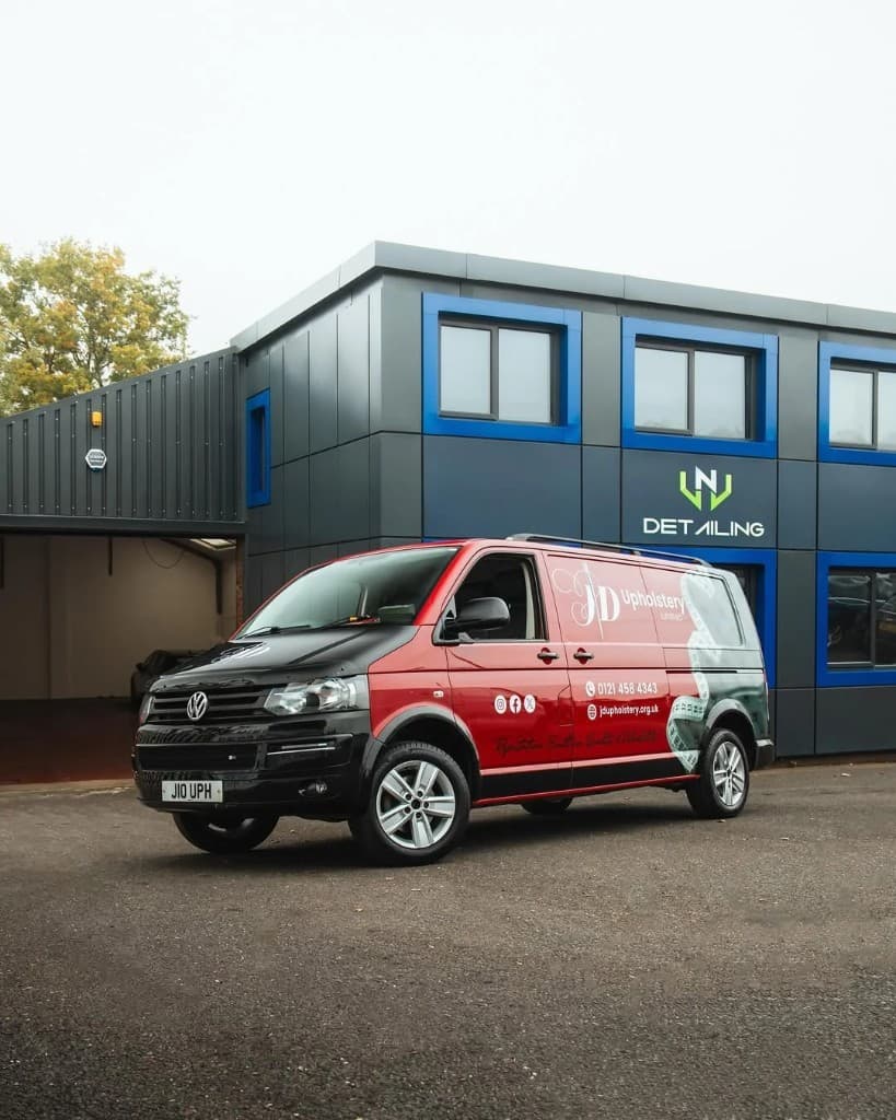 JD Upholstery branded VW Transporter wrap outside JnJ Detailing studio — bold vehicle graphics by JnJ