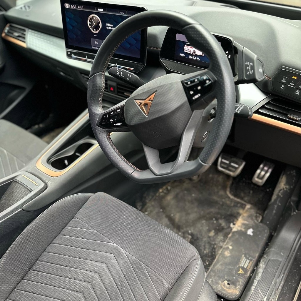 Cupra Born driver footwell before — carpet caked in dried mud and grime