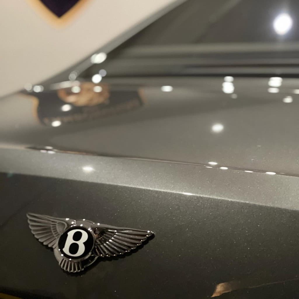 Ferrari badge on flawless Rosso Corsa paintwork after detailing