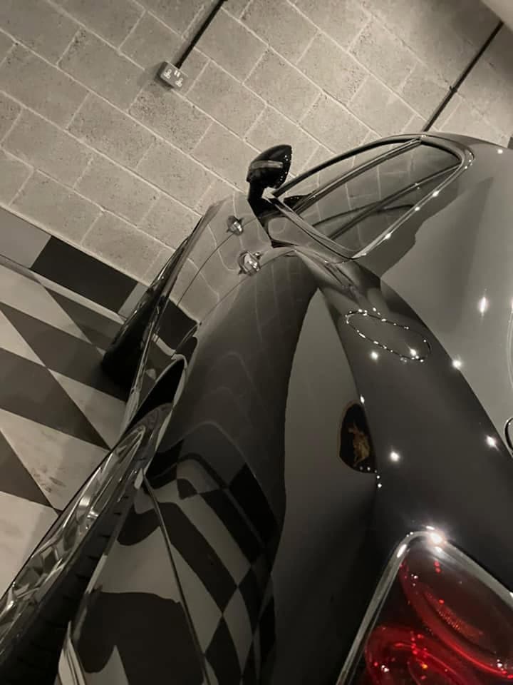 Close-up of flawless paint protection film wrapped around a piano-black pillar — seamless, invisible edge